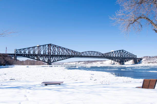 The Quebec Bridge is a mixed rail and road bridge that crosses the St. Lawrence River west of Quebec City to Lévis on the south shore. It is still considered today as a major work of engineering.