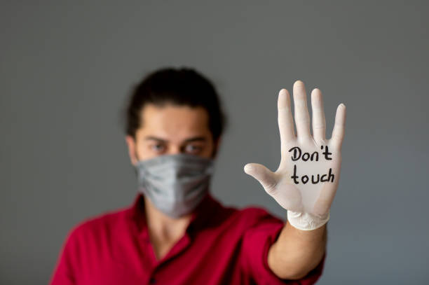 istock The glove-wearer has a message to stop the Coronavirus 1210624402