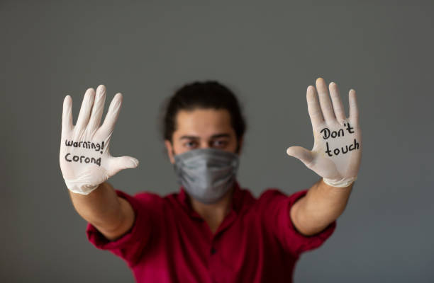 istock The glove-wearer has a message to stop the Coronavirus 1210624526