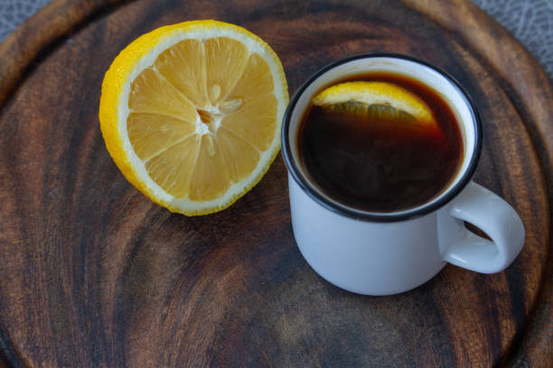 istock A cup of black coffee with a slice of lemon on a grey tablecloth, selective focus 1210626788