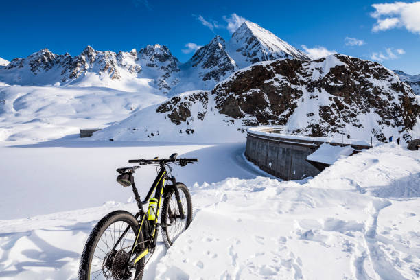 istock Mountain biking in the snow in the high mountains 1210626865