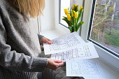 Woman holding paper with UX website design wireframe. Sketch, prototype, framework, layout future design project. UI/UX - user interface, user experience designer. Creative concept for web design studio