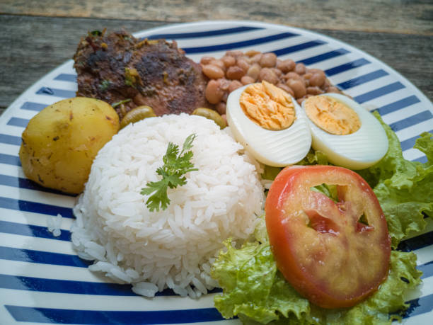 istock Food dish. Beans, rice, meat, salad, egg. Rustic wood background. 1210627188