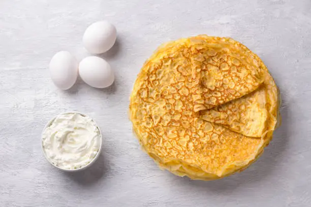 Delicious homemade Low Carb Diet Keto Pancakes without flour and nuts with ingredients for cooking on gray textured background, top view. Ketogenic concept