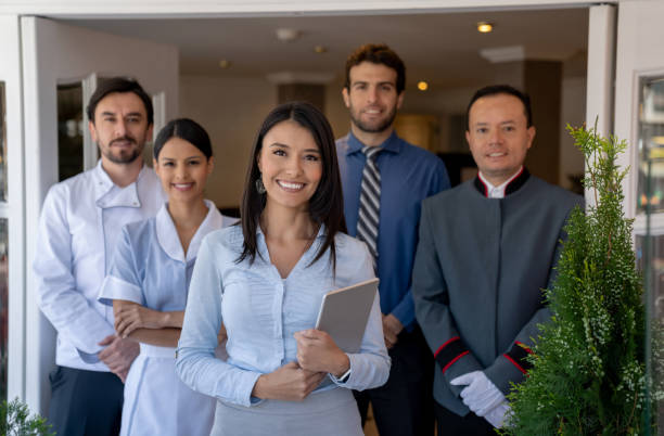 Group of workers at a hotel Happy group of Latin American workers at a hotel and looking at the camera smiling hotel stock pictures, royalty-free photos & images
