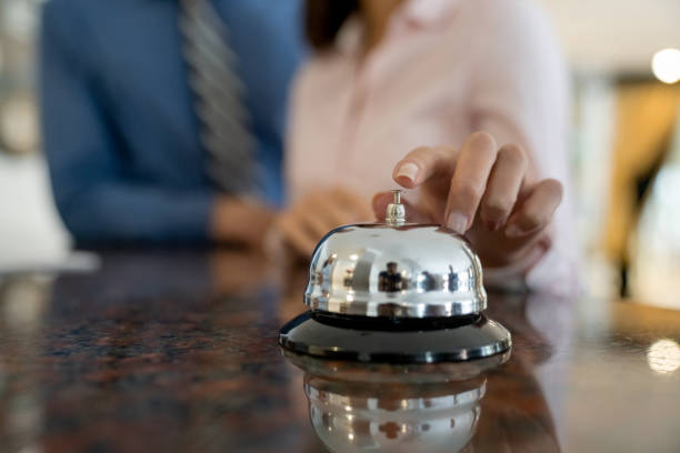 istock Close-up on a couple ringing the service bell at a hotel 1210630188