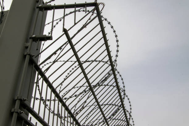 istock A metal fence with barbed wire as an insurmountable barrier 1210630934