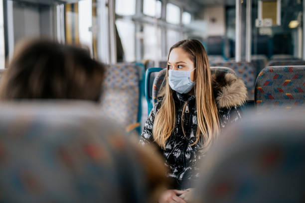 istock Young girl wearing protective face mask sitting on a train 1210631899