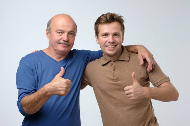 istock Two happy men father and son with thumbs up gesture 1210632739