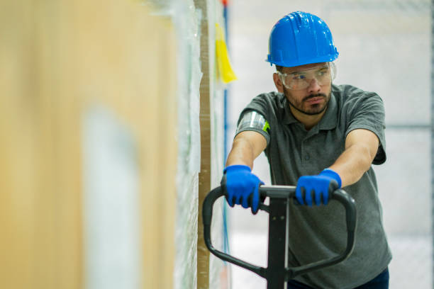istock Worker driving a pallet truck in a warehouse 1210633020