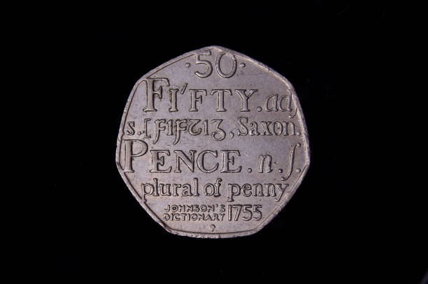 istock Commemorative 50 pence UK coin isolated on the black background 1210633025