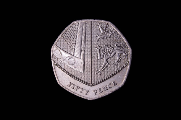 istock Commemorative 50 pence UK coin isolated on the black background 1210633046