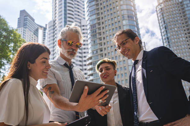istock Hipster manager showing his ideas on a digital tablet to his team 1210634277