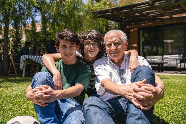 istock Multi-generation family relaxing in the back yard 1210634797