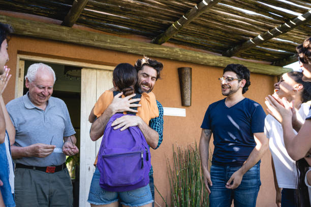 istock Joyful dad hugging his daughter after her study trip 1210634843