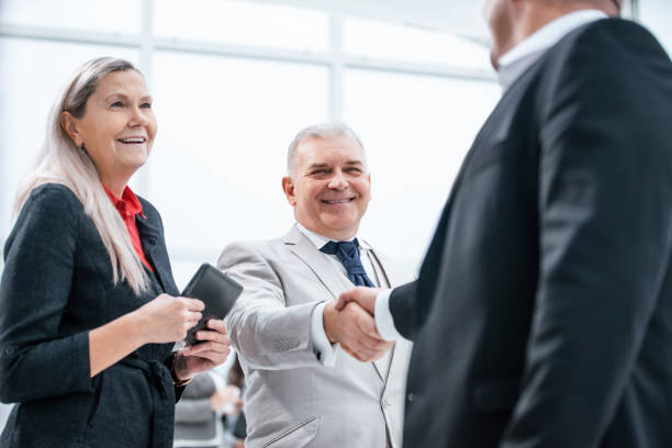 istock close up. confident business people shaking hands with each other. 1210636785