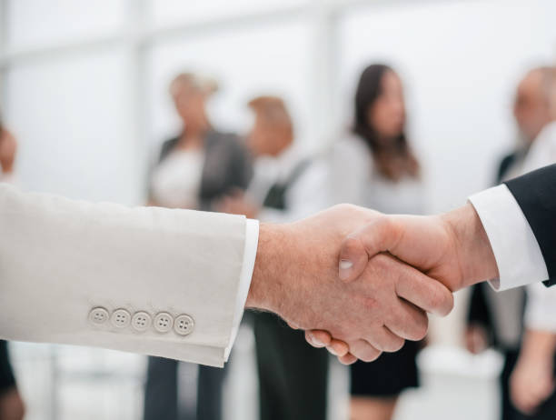istock close up. business handshake on office background. 1210636808