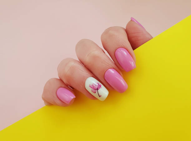 istock female hand beautiful manicure on a colored background, floral 1210637182