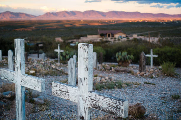 dwa drewniane krzyż grobowe markery z widokiem na zachód słońca nad wzgórzami na cmentarzu boothill w tombstone - cross shape cross grave nobody zdjęcia i obrazy z banku zdjęć