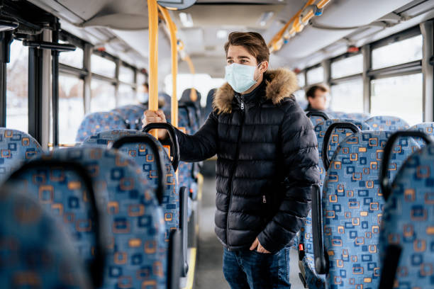 istock Young male standing on a bus wearing sterile face mask 1210644609