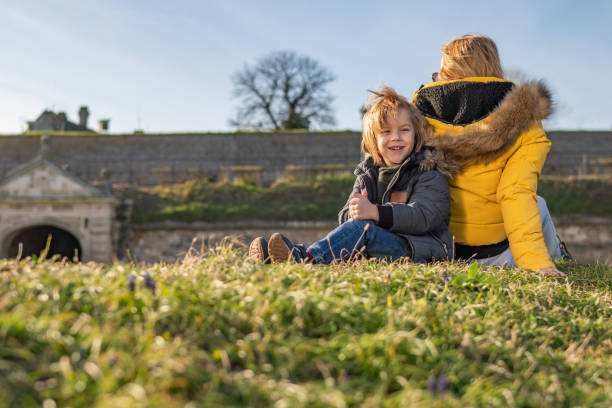 istock Boy and mom on the grass back to back 1210646046