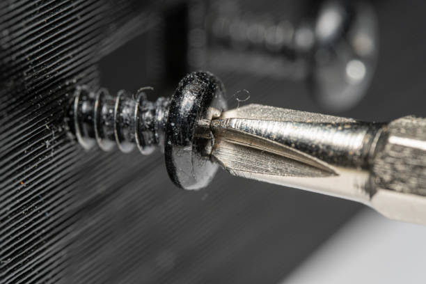 Macro photo of a screwdriver being used Macro photo of a small screwdriver being used to screw a small screw into a 3D printer part screwdriver photos stock pictures, royalty-free photos & images