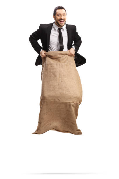 istock Cheerful businessman jumping in a sack and looking at camera 1210649167