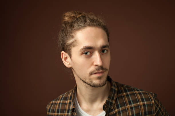 istock studio portrait of a young man with a beard on a brown background 1210649218