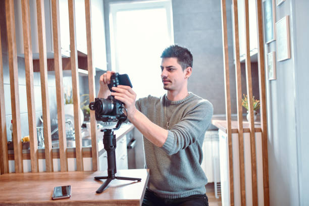 istock Handsome Male Journalist Ready to Record Interview With Video Camera 1210649225