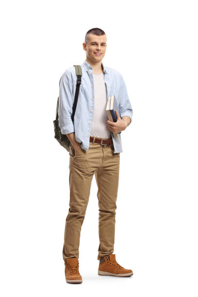 istock Male student with books and backpack and smiling at the camera 1210649434