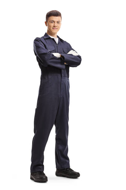 young guy in an overall worker uniform posing and smiling - manual worker full length isolated on white standing imagens e fotografias de stock