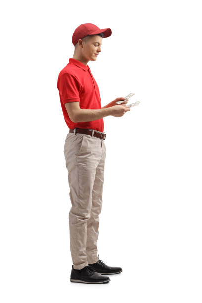 istock Guy cashier in a uniform counting money 1210650184