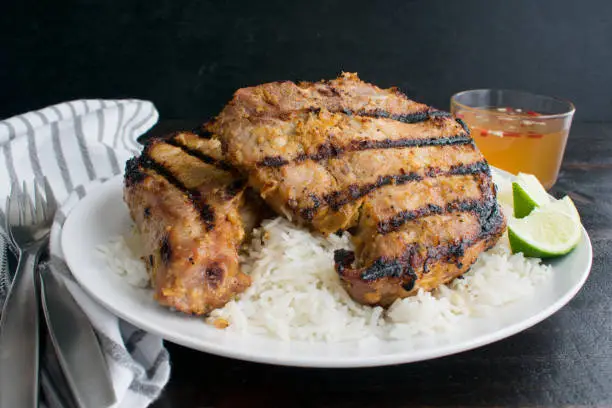 Grilled pork chops that have been marinated in a lemongrass sauce