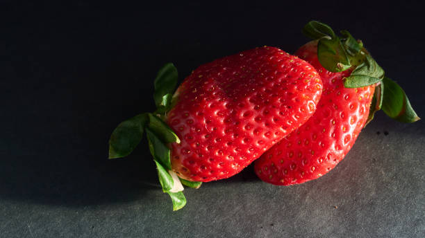 strawberries with natural light and black background