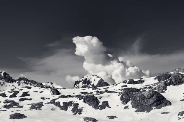 istock Snowy rocks and sky with clouds at nice day 1210658901