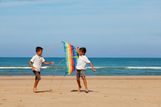 istock Two happy handsome little boys play with kite 1210659176