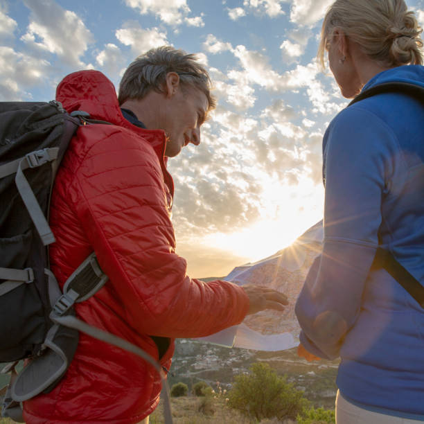 istock Mature hikers consult map for direction ahead 1210661850