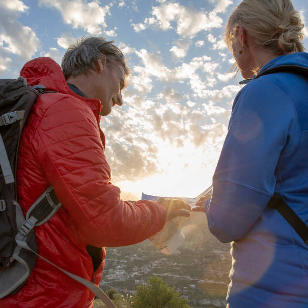 istock Mature hikers consult map for direction ahead 1210661852