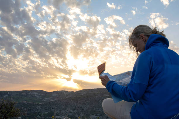 istock Mature female hiker consults map for direction ahead 1210661881