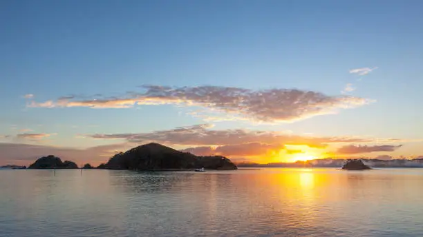 Sunrise at the Bay of Islands, an area on the east coast of the Far North District of the North Island of New Zealand. It is one of the most popular fishing, sailing and tourist destinations in the country.