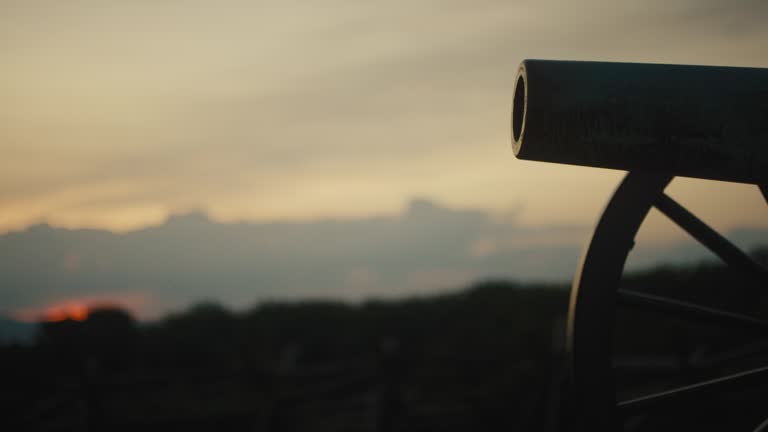 Rack Focus Shot of a Silhouette of a US Civil War Cannon from Gettysburg National Military Park, Pennsylvania at Sunset