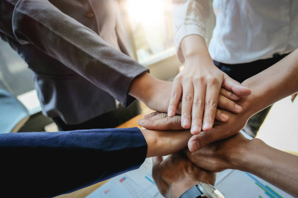 istock Teamwork Success.  Business people group team happy showing teamwork and joining hands after meeting partner business in office. Business Concept 1210669616