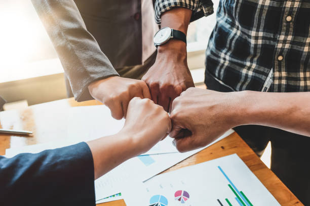 istock Teamwork Success.  Business people group team happy showing teamwork and joining hands after meeting partner business in office. Business Concept 1210669651