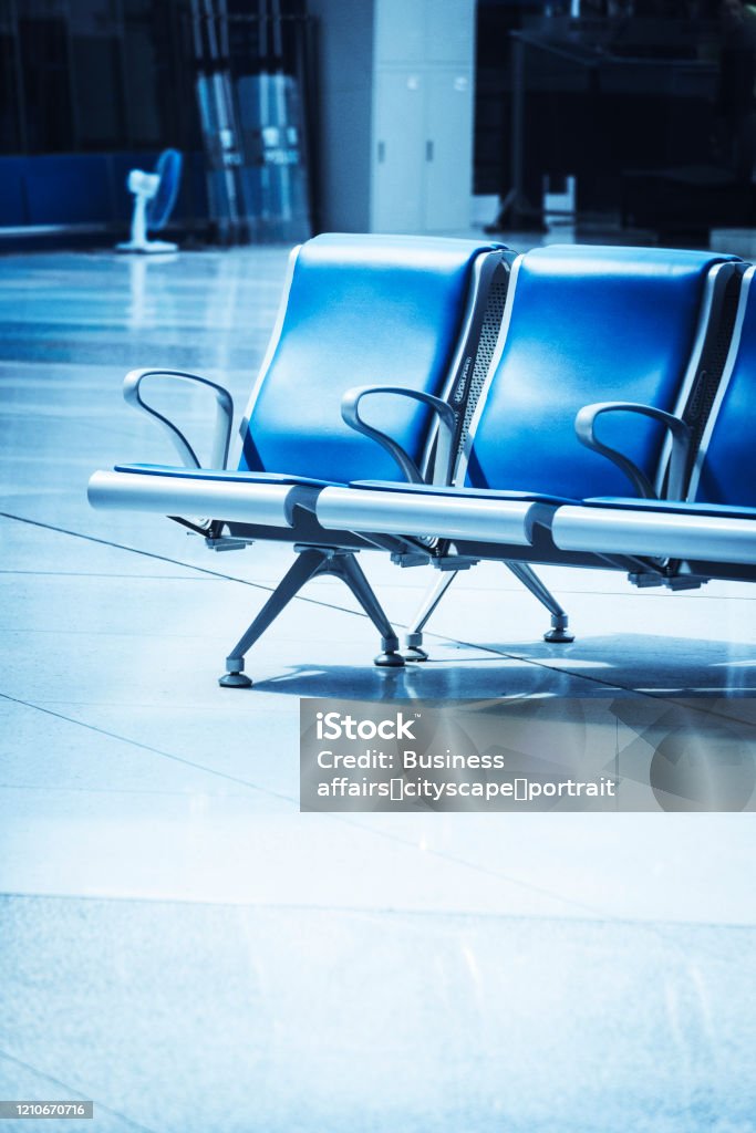 In a station, there are blue seats inside. Adventure Stock Photo