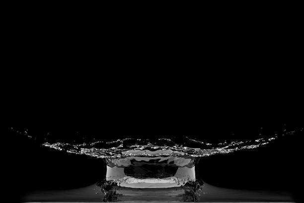 istock Close up Liquid Water Droplet Collision splash on black background. 3D Render 1210670825