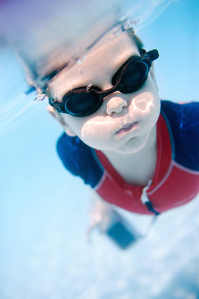 istock Little boy swimming underwater 121067274