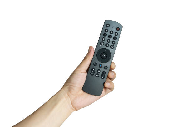 istock His hand is holding the remote control and operate the remote control. on the White Background . Concept of Technology 1210675407