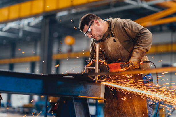 istock Factory worker cutting metal with grinder. 1210675641