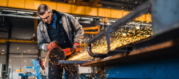 istock Factory worker cutting metal with grinder. 1210678112
