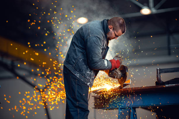istock Factory worker cutting metal with grinder. 1210678687